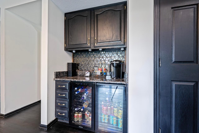 12627 Oakmere Dr, Pickerington, OH 43147 - indoor dry bar with wine cooler, decorative backsplash, dark wood-style floors, and baseboards