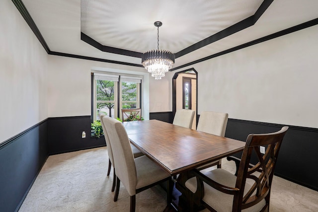12627 Oakmere Dr, Pickerington, OH 43147 - dining room featuring a chandelier, a wainscoted wall, crown molding, a raised ceiling, and light carpet