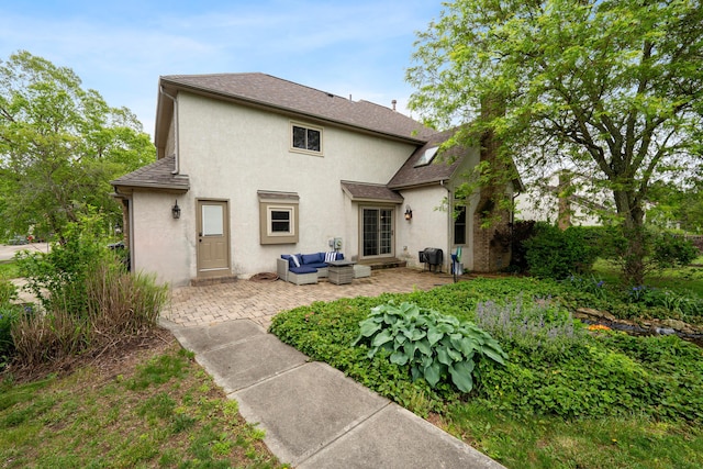12627 Oakmere Dr, Pickerington, OH 43147 - back of property featuring stucco siding, an outdoor living space, a patio area, and roof with shingles