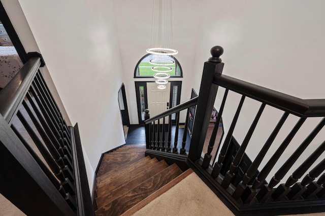 12627 Oakmere Dr, Pickerington, OH 43147 - staircase featuring a high ceiling, a chandelier, and carpet
