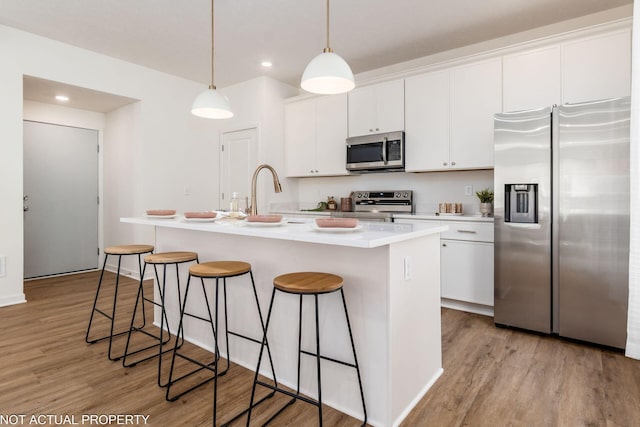 344 Postle Blvd, Columbus, OH 43228 - kitchen featuring white cabinetry, light wood finished floors, an island with sink, and stainless steel appliances