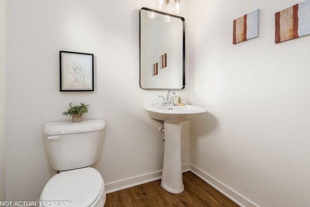 344 Postle Blvd, Columbus, OH 43228 - bathroom with baseboards, toilet, and wood finished floors