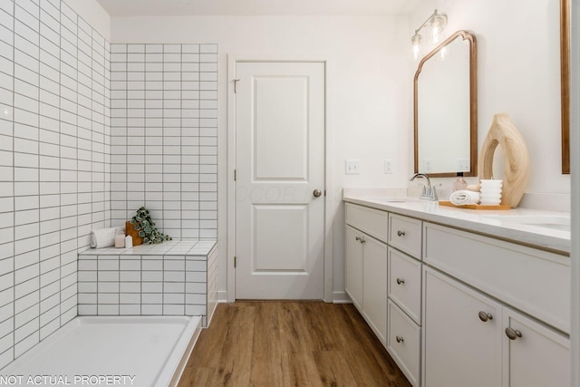 344 Postle Blvd, Columbus, OH 43228 - full bathroom with wood finished floors, double vanity, a sink, and tiled shower