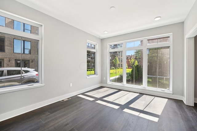 unfurnished room with dark hardwood / wood-style floors