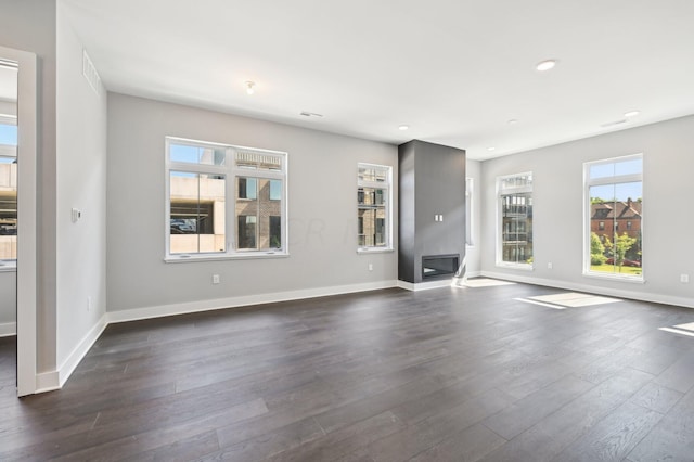 unfurnished living room featuring dark wood-type flooring