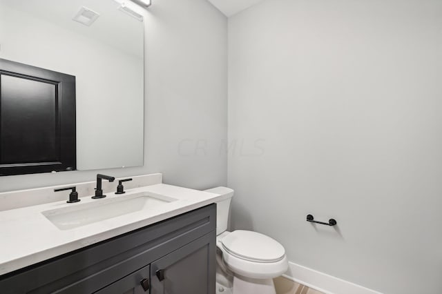 bathroom featuring vanity and toilet