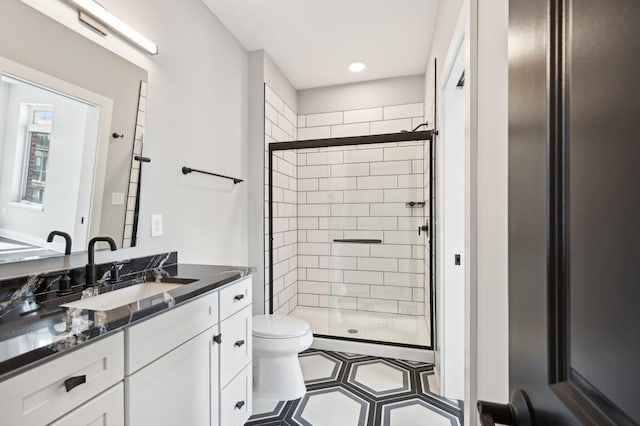 bathroom with vanity, an enclosed shower, and toilet