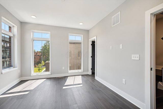 empty room with dark hardwood / wood-style flooring