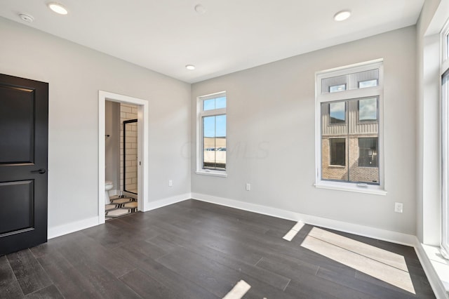 unfurnished room featuring dark hardwood / wood-style floors