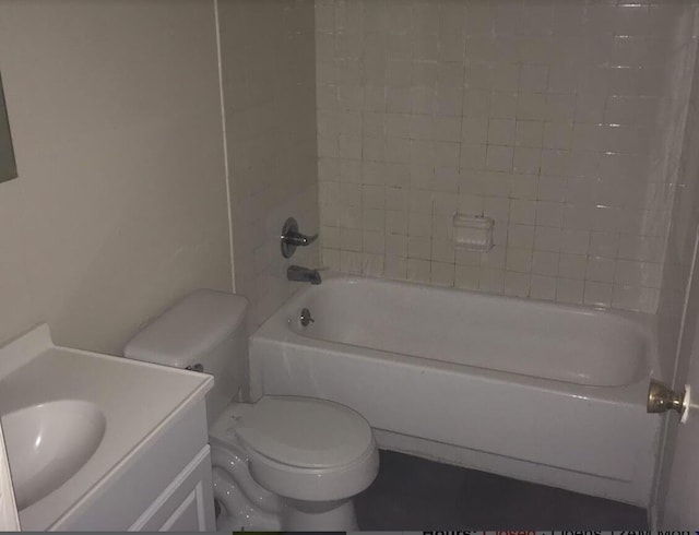 full bathroom with vanity, tiled shower / bath combo, and toilet