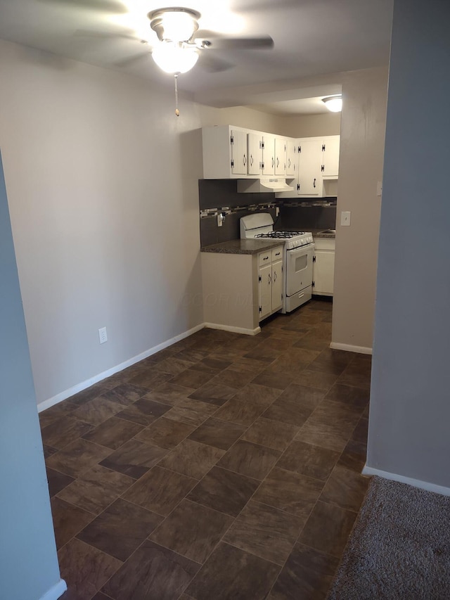 4714 Tarryton Ct S Unit 20-1G, Columbus, OH 43228 - kitchen with white range with gas cooktop, a ceiling fan, dark countertops, white cabinetry, and under cabinet range hood