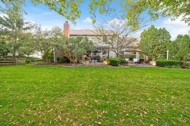 view of yard featuring a patio and fence