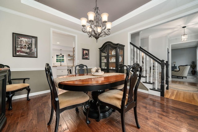 dining area featuring crown molding, stairs, wood-type flooring, baseboards, and a notable chandelier