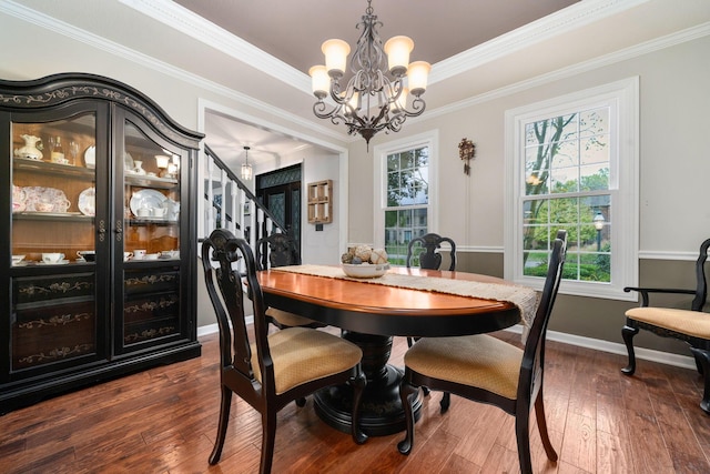 dining area with stairway, dark wood finished floors, a wealth of natural light, and a notable chandelier