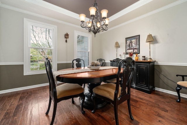 dining area with a chandelier, crown molding, baseboards, and dark wood-style floors