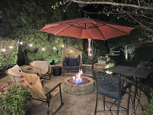 patio at twilight featuring a fire pit