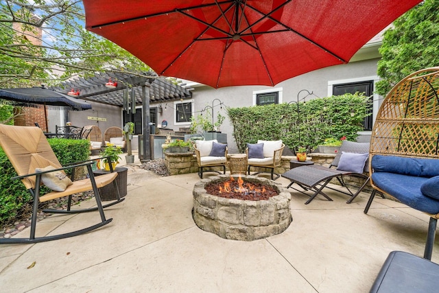 view of patio with a fire pit, a pergola, and outdoor dining area