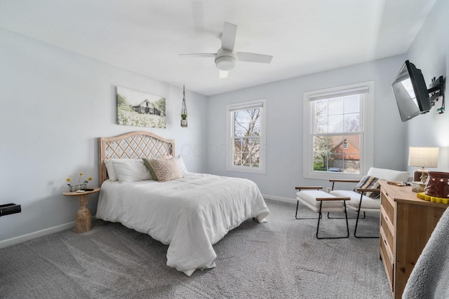 bedroom featuring baseboards, light colored carpet, and ceiling fan