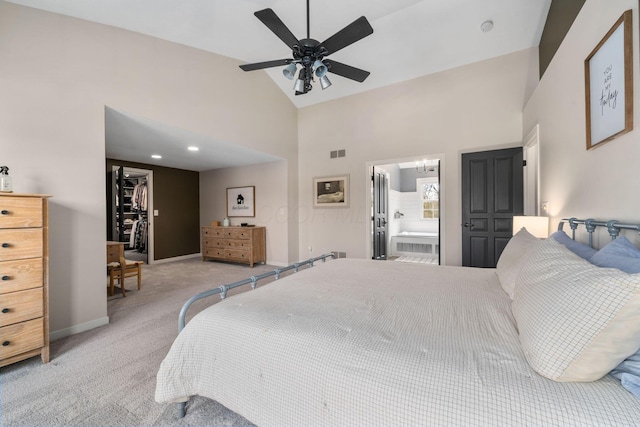 bedroom featuring carpet flooring, baseboards, a spacious closet, ensuite bath, and high vaulted ceiling