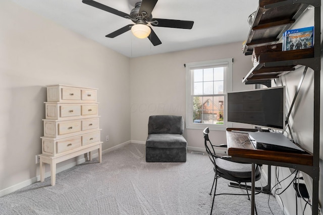 office area featuring ceiling fan, baseboards, and light carpet