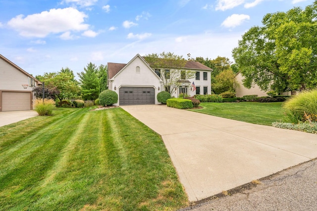 view of front of home with driveway, a front yard, and stucco siding