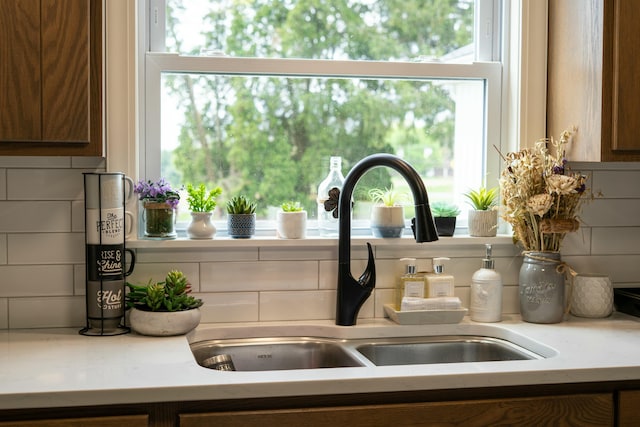 interior details with brown cabinets, light countertops, and a sink