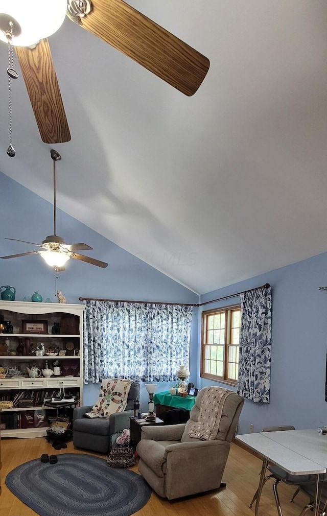 living room featuring light hardwood / wood-style flooring, ceiling fan, and lofted ceiling