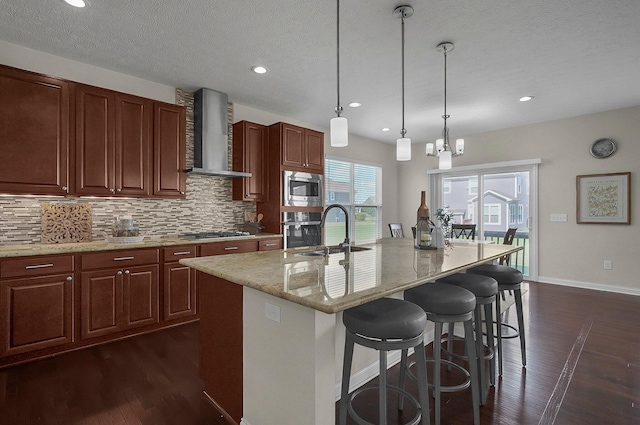 5421 Mercier St, Lewis Center, OH 43035 - kitchen with wall chimney exhaust hood, a sink, appliances with stainless steel finishes, decorative backsplash, and dark wood-style flooring