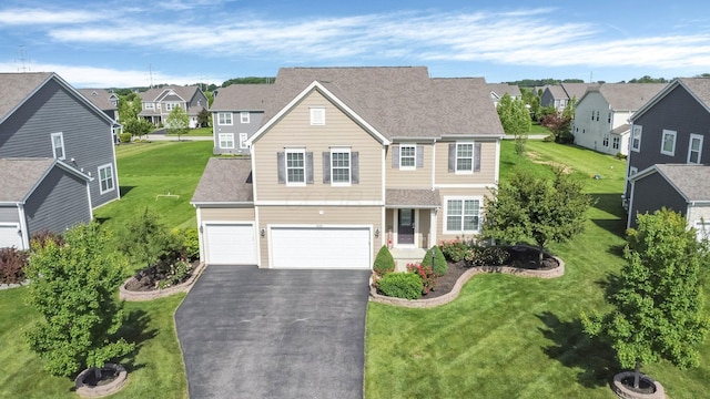 5421 Mercier St, Lewis Center, OH 43035 - traditional-style house with a residential view, asphalt driveway, a garage, and a front lawn