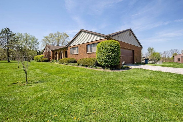 view of side of home with a lawn and a garage