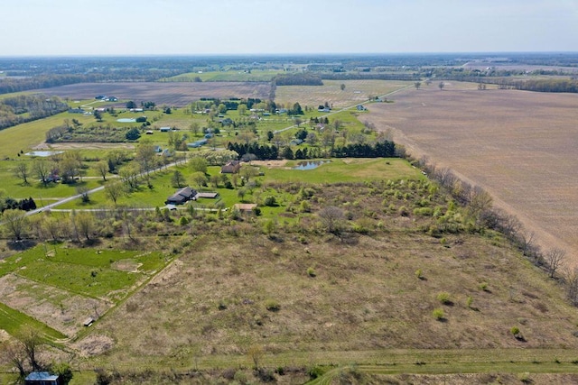 birds eye view of property with a rural view