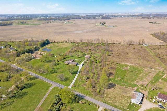 birds eye view of property with a rural view