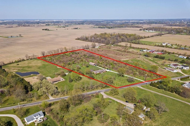 birds eye view of property with a rural view