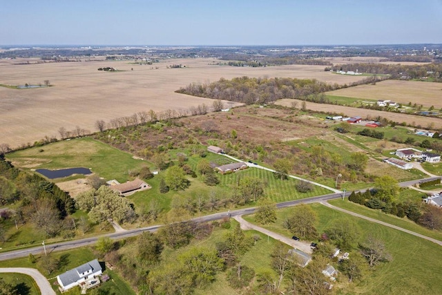 birds eye view of property with a rural view