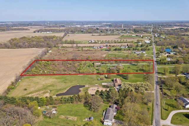 birds eye view of property with a rural view