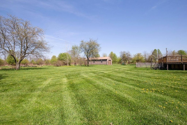 view of yard featuring a rural view and a deck