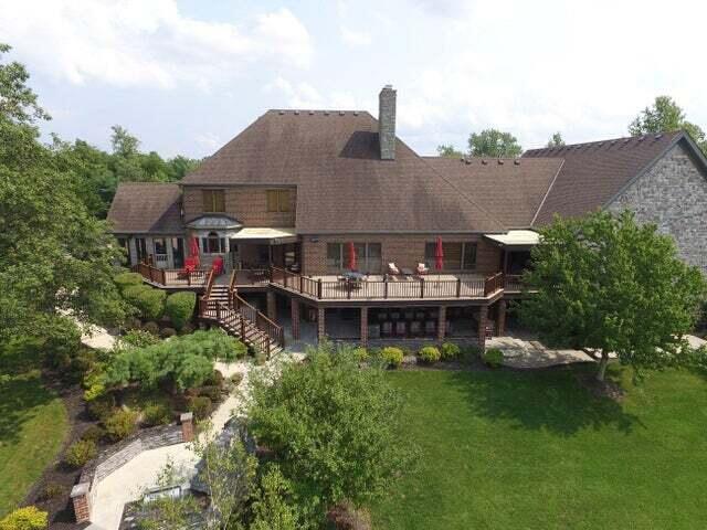 rear view of house featuring a deck and a yard