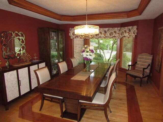 dining room featuring light hardwood / wood-style floors and a raised ceiling