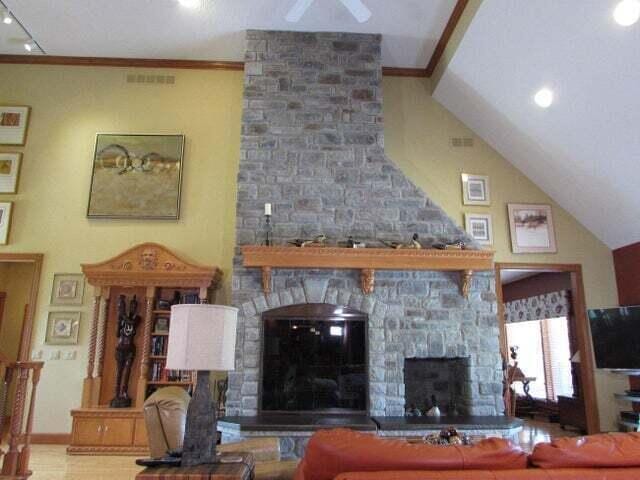 living room with vaulted ceiling and a fireplace