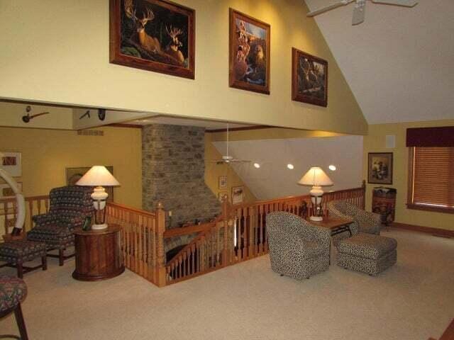 interior space featuring ceiling fan, high vaulted ceiling, and carpet flooring