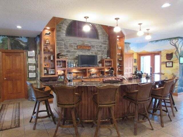 bar with a textured ceiling, tile patterned floors, and decorative light fixtures