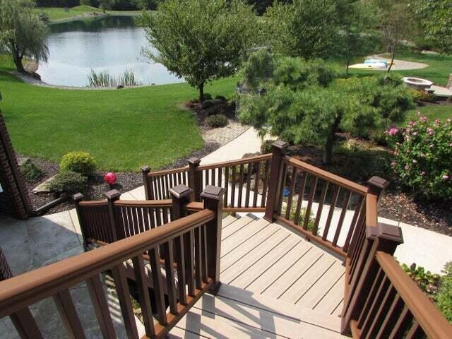 wooden deck featuring a water view and a yard