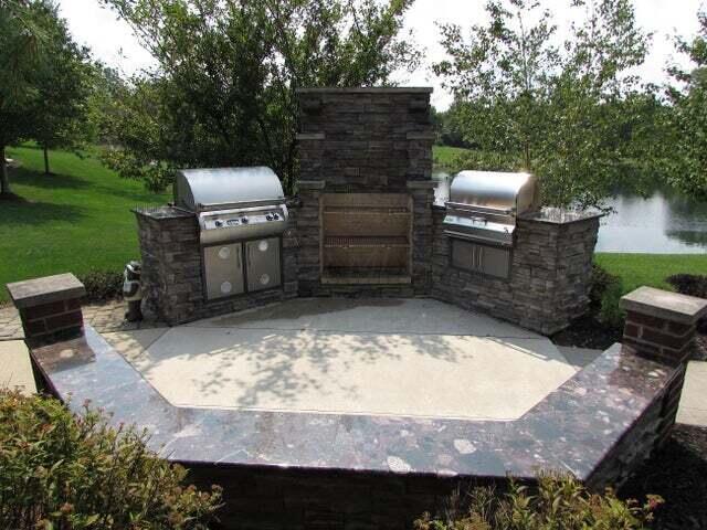 view of patio / terrace with grilling area, an outdoor kitchen, and a water view