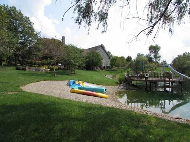 view of community featuring a water view and a lawn