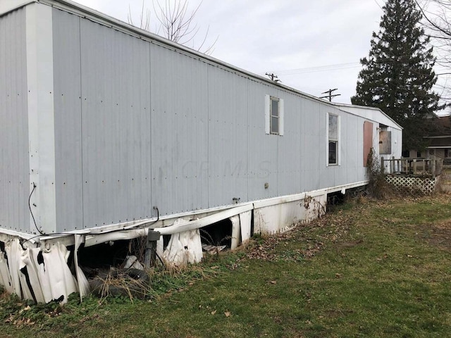 view of side of property with a lawn