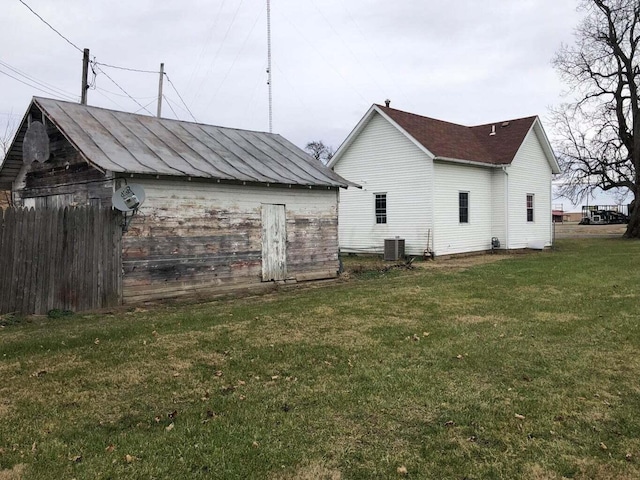 exterior space with a lawn and central AC