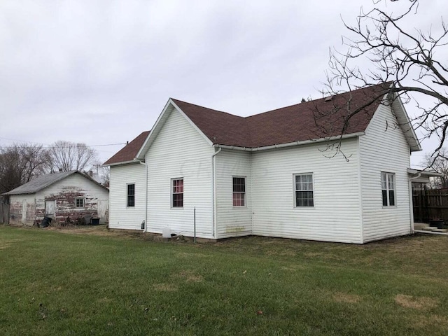 rear view of property with a yard