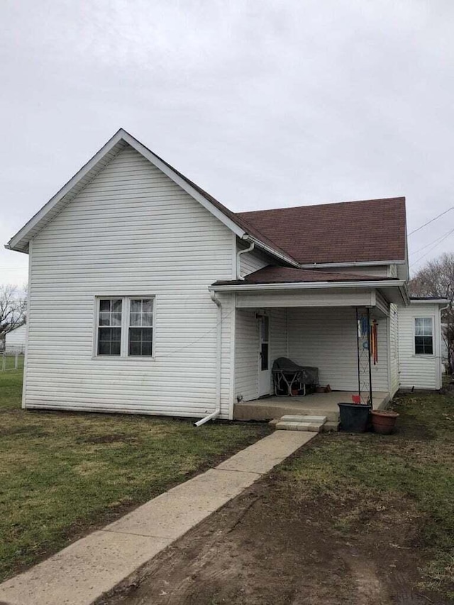 back of house with a yard