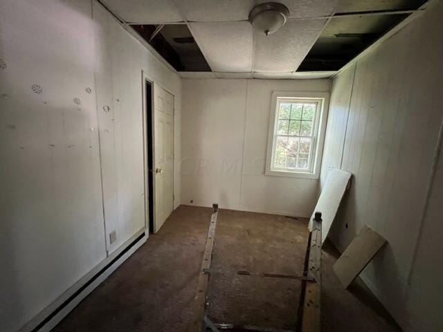 unfurnished room with a baseboard heating unit