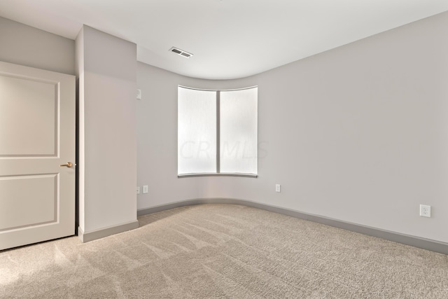 spare room with light colored carpet